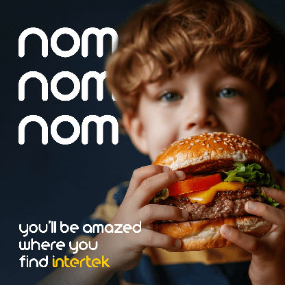 Young boy holding a tall hamburger